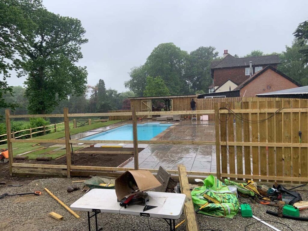 This is a photo of Bespoke custom fencing installed around a swimming pool by Fast Fix Fencing Sheppey