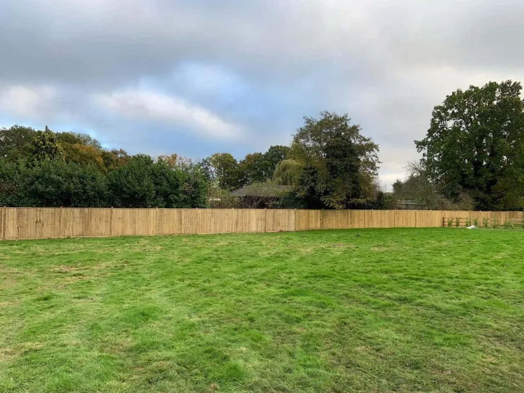 This is a photo of feather edge fencing installed around the edge of a field by Fast Fix Fencing Sheppey
