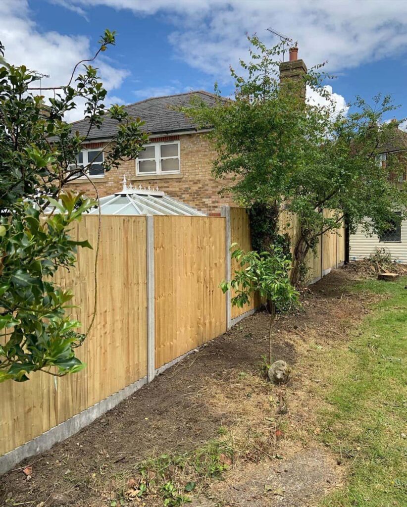 This is a photo of fence panels installed in a residential garden using concrete posts and gravel boards. Installed by Fast Fix Fencing Sheppey
